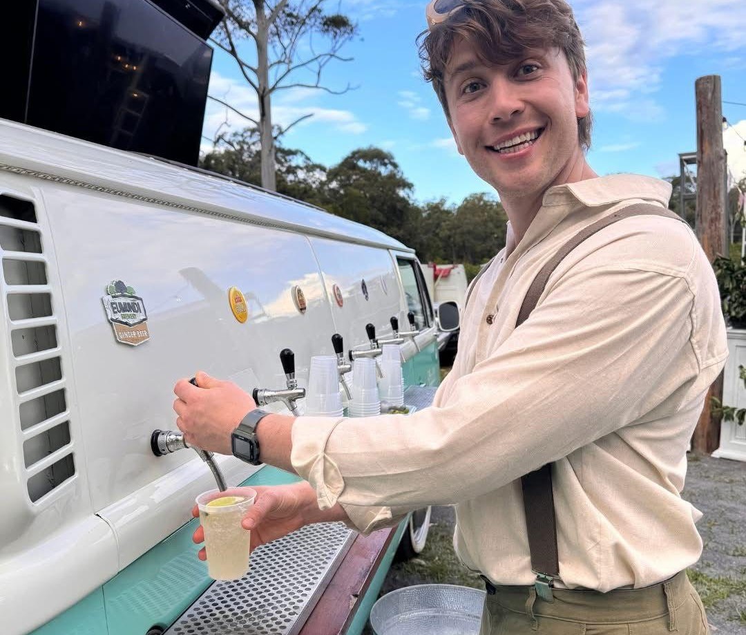 The Drink Up van lit up at night for an evening event.