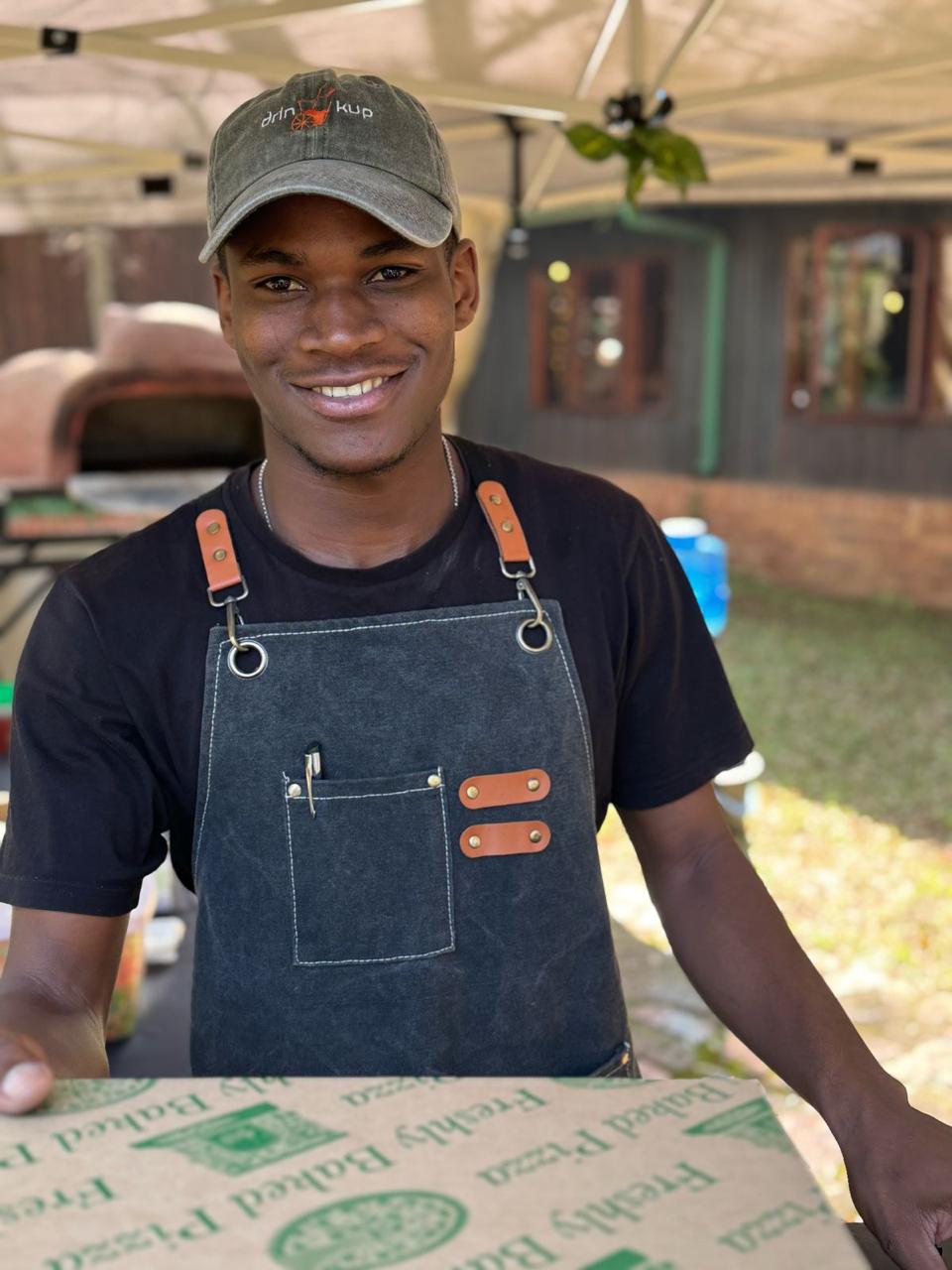 A wood-fired pizza with pepperoni and basil.